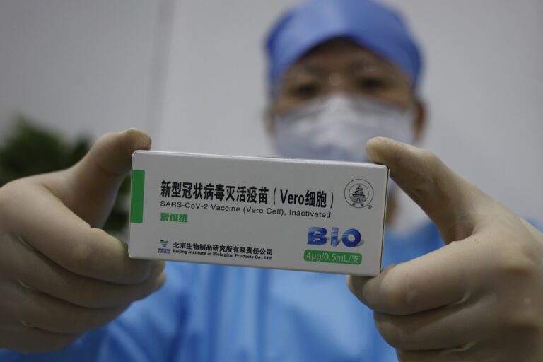 A-medical-worker-shows-the-COVID-19-vaccine-produced-by-Sinopharm.-_3xjaWPm