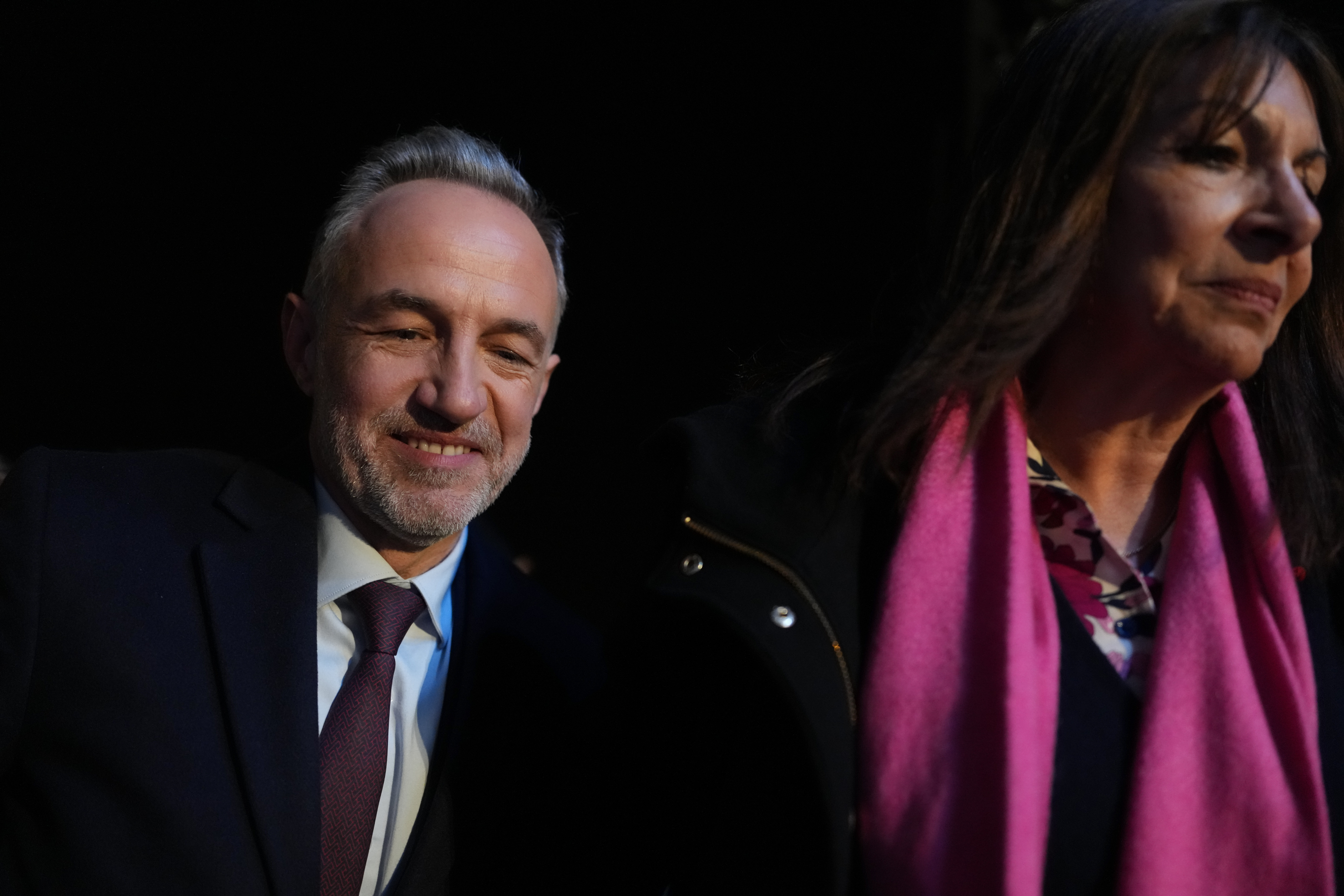 French socialist candidate for Paris mayoral election Emmanuel Gregoire, left, and Anne Hidalgo arrives to give a speech after Gregoire won the second round of France's municipal elections in Paris, Sunday, March 22, 2026. (AP Photo/Thibault Camus)